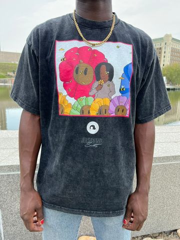 A model wearing a graphic JOHNSONANDSCOTT and Halfmoonstudioz collaboration shirt.