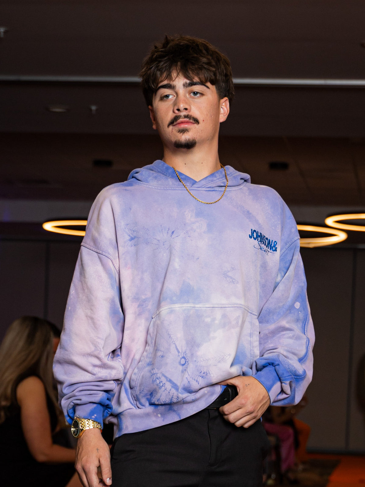 Model wearing the purple reworked Marble Hoodie in an indoor portrait