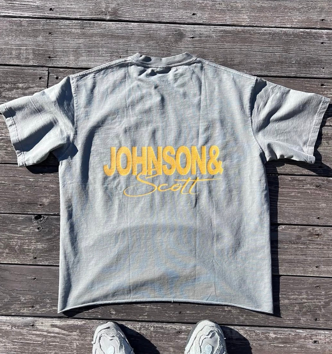 Back flat lay of gray Tiger T-Shirt with yellow JOHNSONANDSCOTT signature