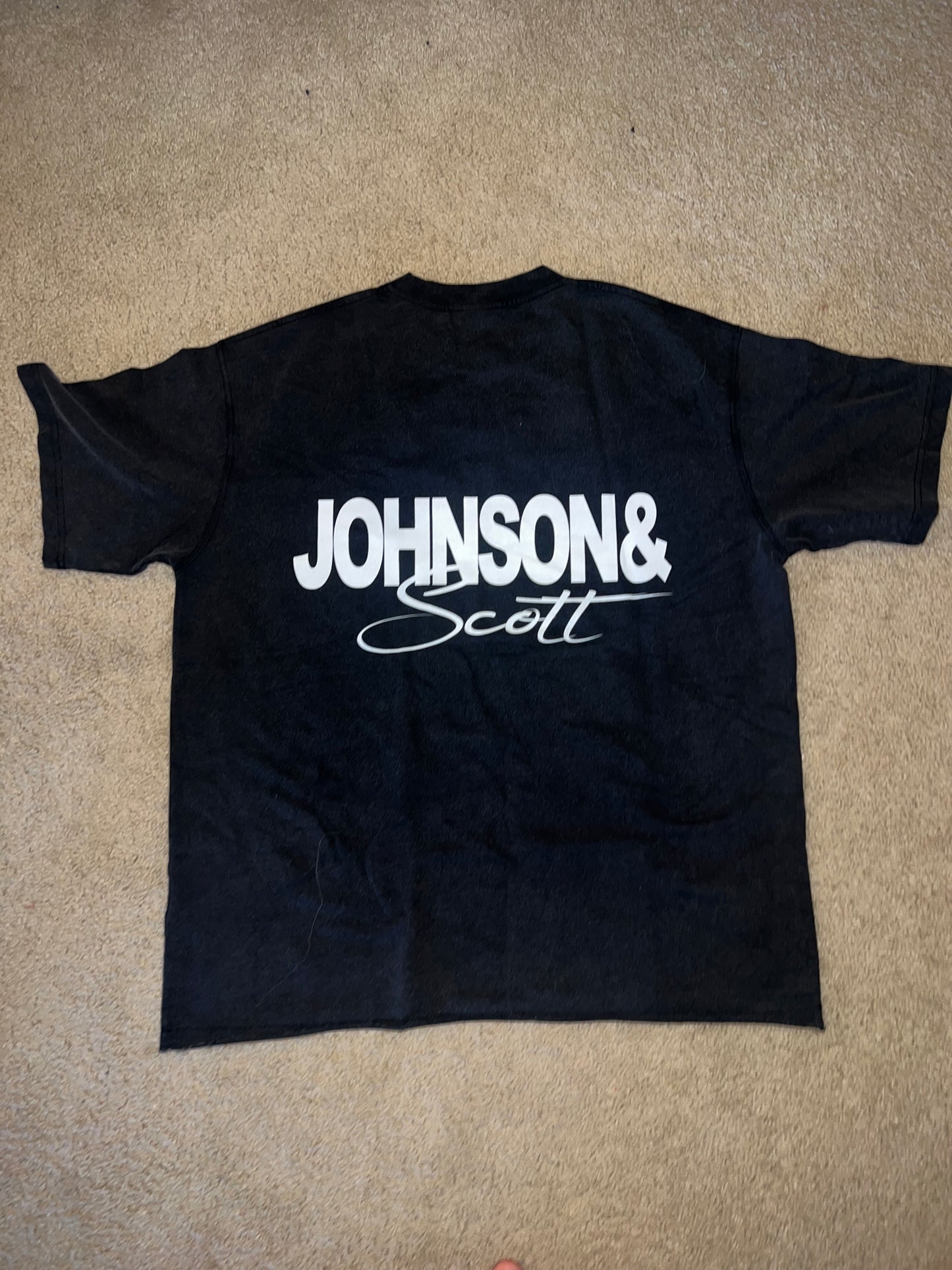 Back flat lay of black Let's Go Outside T-Shirt with white JOHNSONANDSCOTT signature