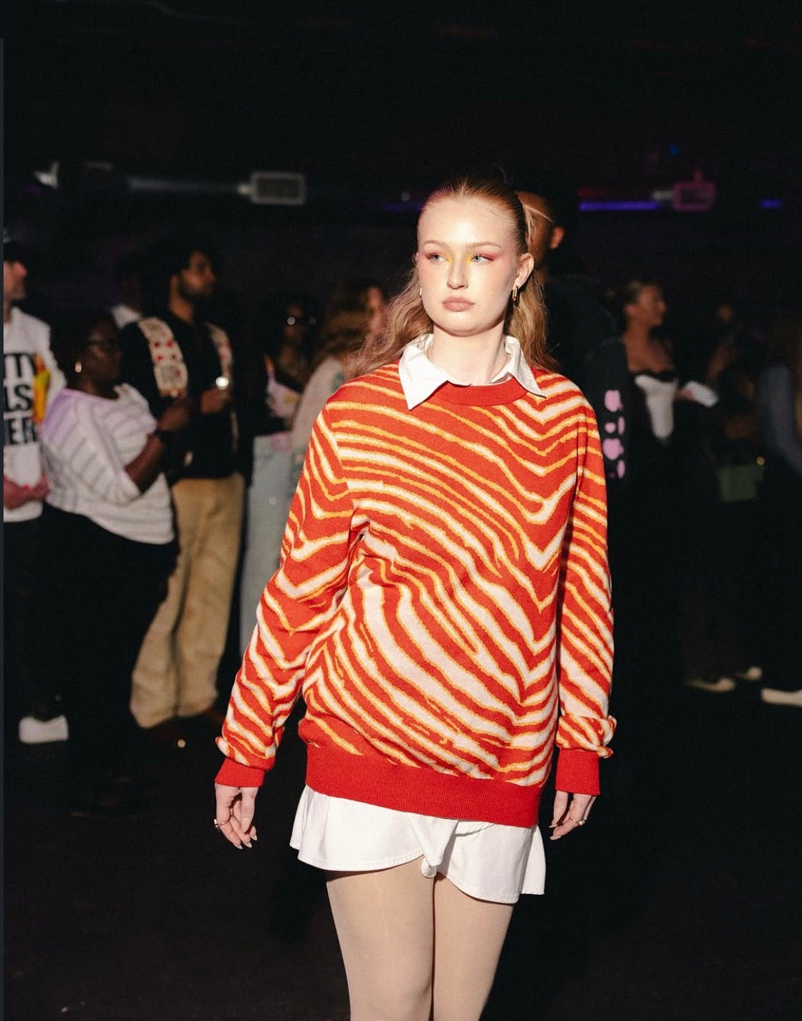 Model wearing the red Champions Striped Knit Sweater on the JOHNSONANDSCOTT runway