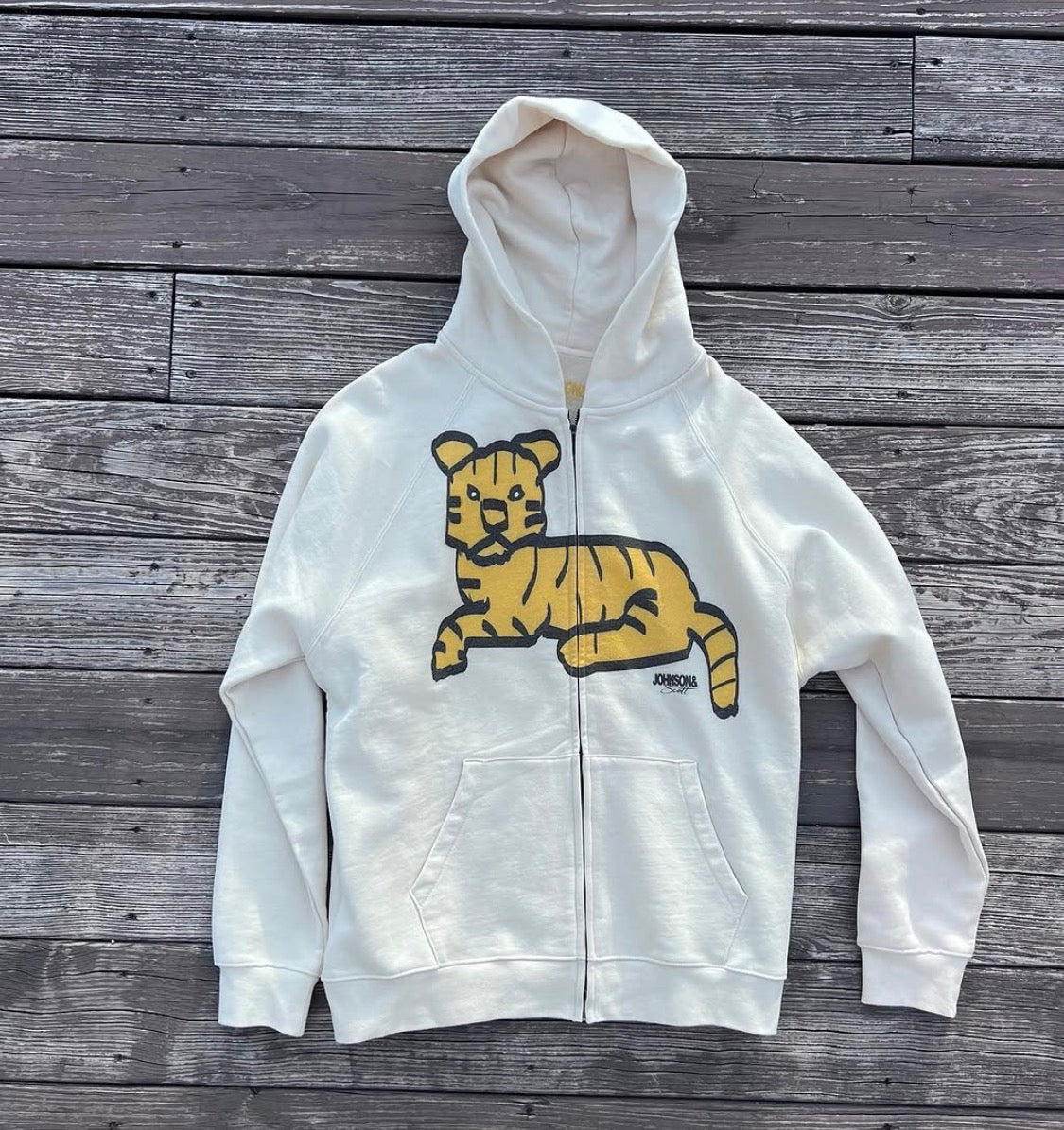 Front flat lay of white Tiger Full Zip Hoodie with yellow tiger graphic
